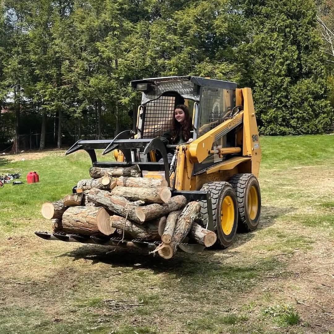 MacKenzie on the CASE skid steer clearing logs — MacKenzie Tree LLC